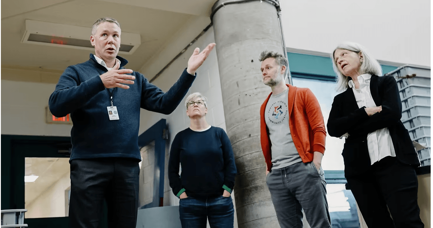 4 people standing in the lobby of the jail, including Col. Martin Kumer